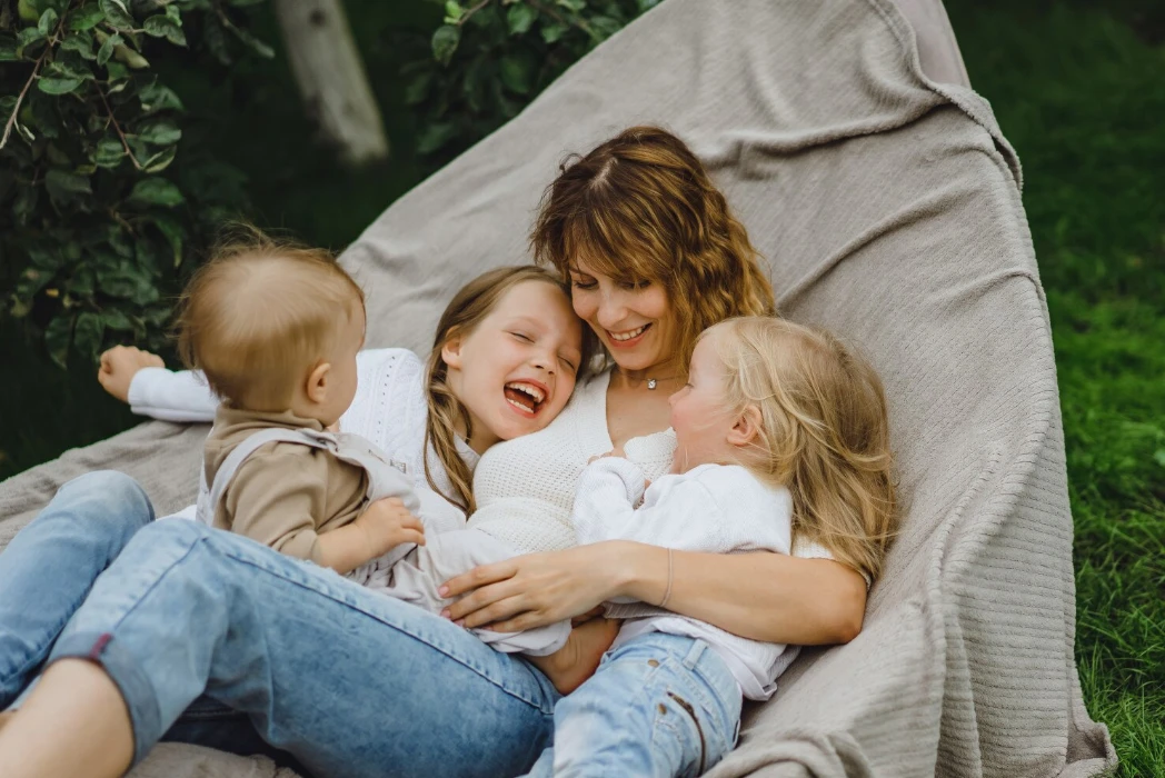 mother with children having fun in a hammock. Mom and kids in a hammock.